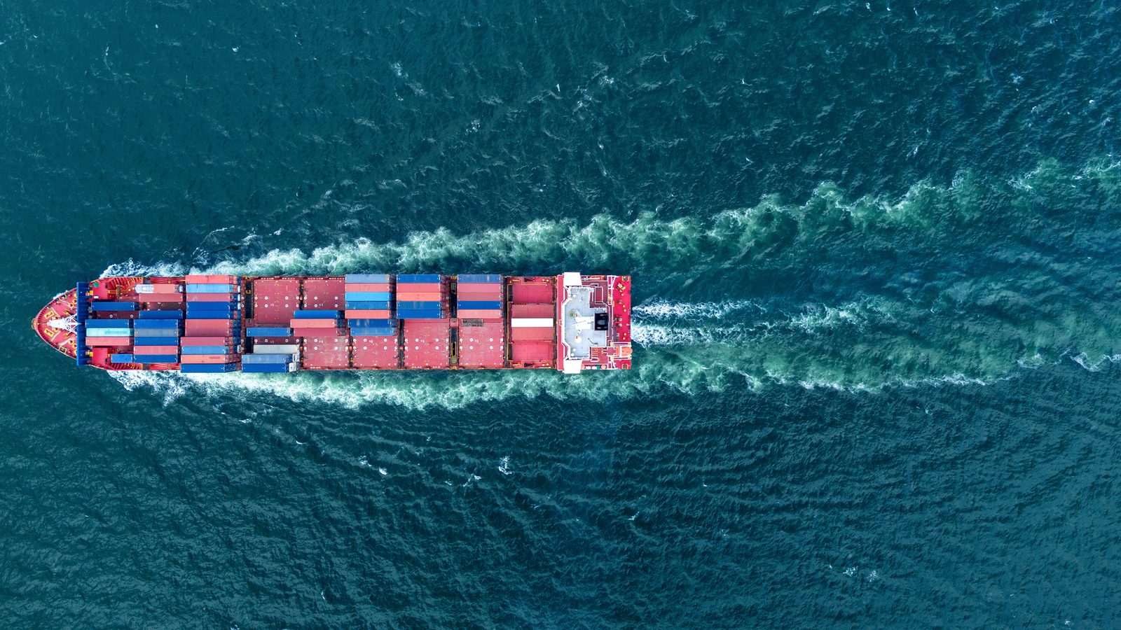 Container ship at sea, international logistics at programme scale