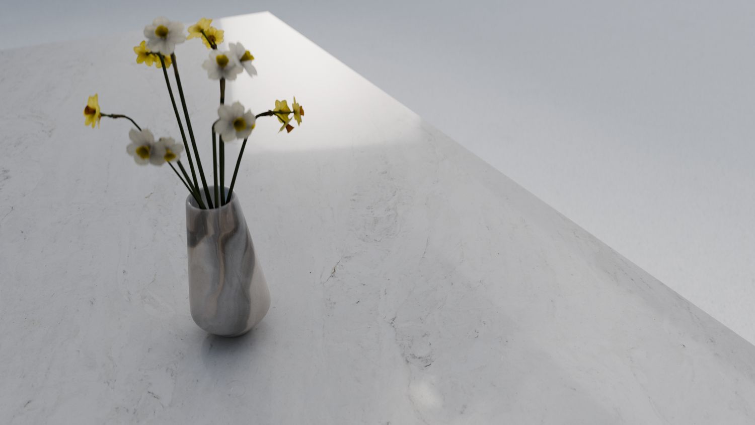 Warm white with faint grey wisps, zero-silica quartz surface ZQ11116, in situ